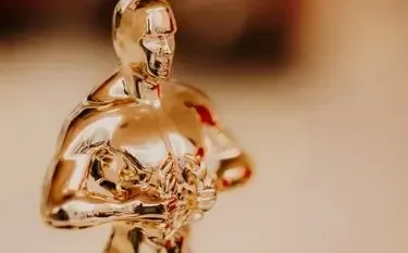 Private Jet Charter to the Academy Awards 2026 Golden oscar statuette gleaming warm light symbolizing hollywood academy awards for private jet charter passengers