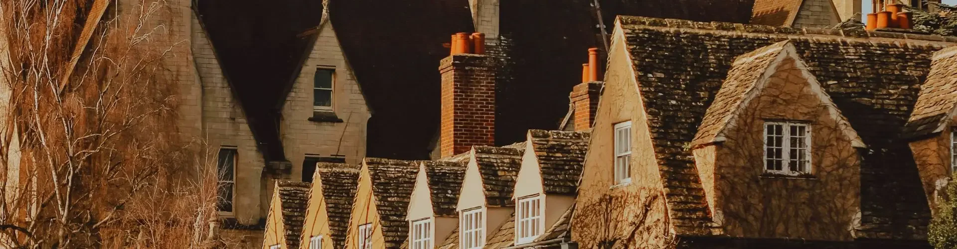 Historic Oxford architecture with golden stone buildings and ivy-covered facades near Oxford Airport