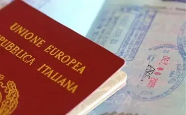 Italian passport with travel stamps showcasing international destinations for luxury jet travel
