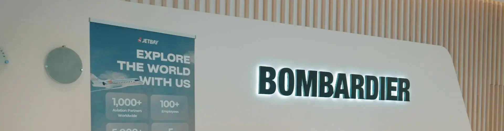 Inside Bombardier’s Expanded Mega Service Centre Modern Bombardier reception area with company branding and promotional banner for luxury aviation networking