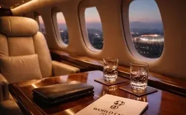 2026 FIFA World Cup Private Jet Charter Guide Luxury private jet cabin leather seating whiskey with glasses city lights visible windows