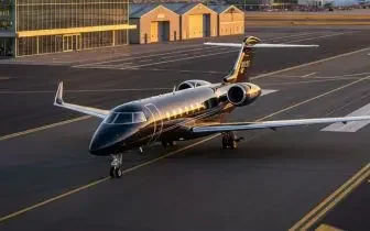 Luxury private jet parked on airport tarmac with modern hangars showcasing UK charter flight options