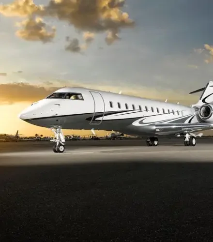 Luxury private jet positioned on tarmac during golden hour sunset for premium Lunar New Year travel