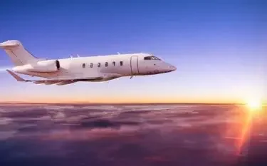 Private Jet Charters: Your Complete Guide for First-Time Flyers (Part 1) Luxury private jet soaring above golden clouds at sunset, showcasing premium business travel comfort