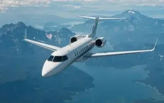 Luxury private jet soaring above Canadian mountain ranges showcasing premium charter flight options