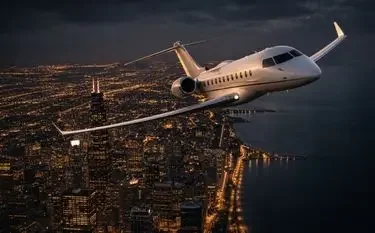 Luxury private jet soaring above illuminated city skyline at dusk showcasing premium charter flight experience
