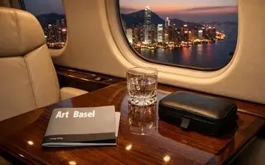 Luxury private private jet cabin art basel brochure whiskey hong kong skyline sunset