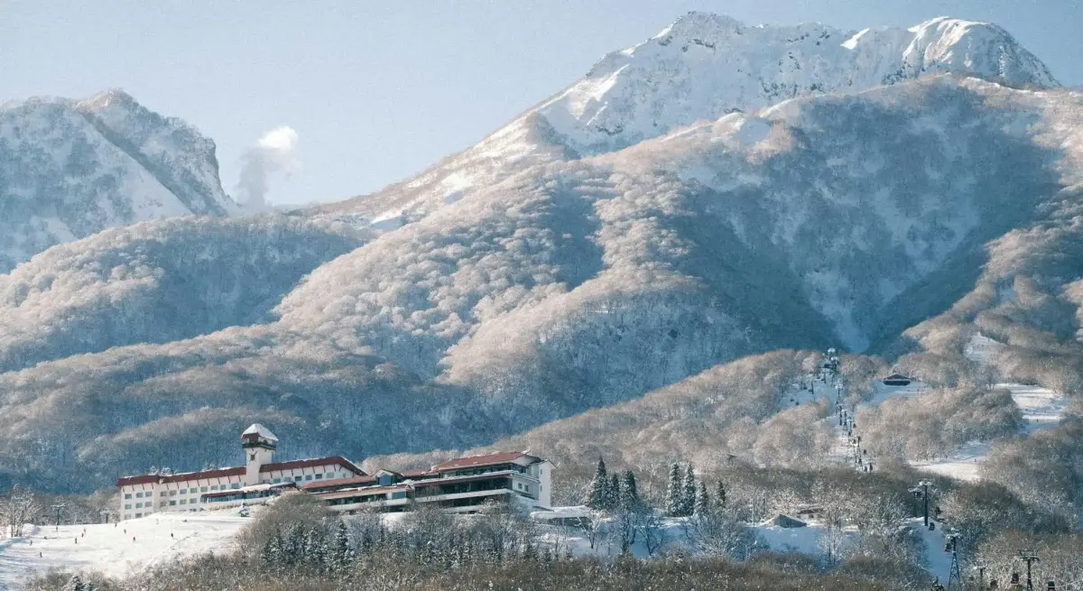 Luxury ski resort nestled in snow-covered mountains with ski lifts, perfect for private jet winter getaways