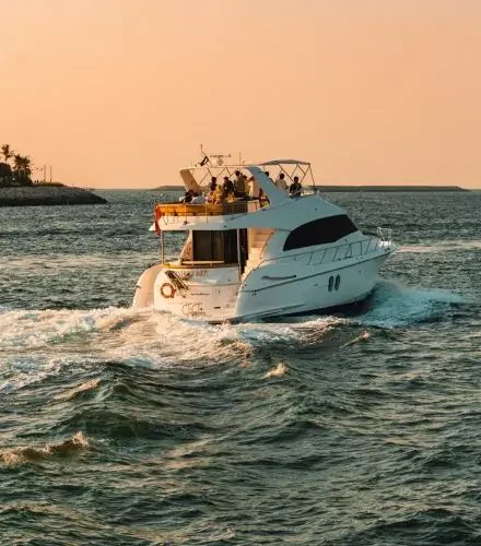 Luxury yacht cruising at sunset showcasing premium lifestyle experiences for exclusive birthday celebrations