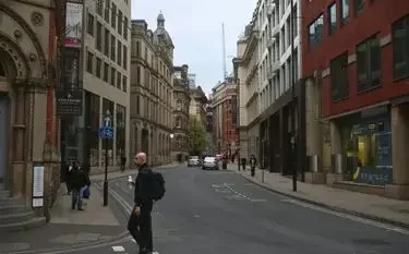 Manchester city center historic architecture pedestrians private jet charter hub