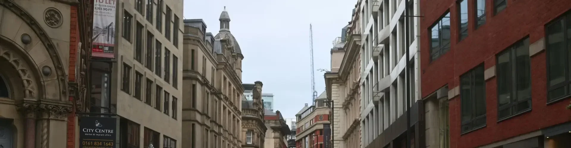 Manchester city center historic architecture pedestrians urban thoroughfare for private jet charter passengers