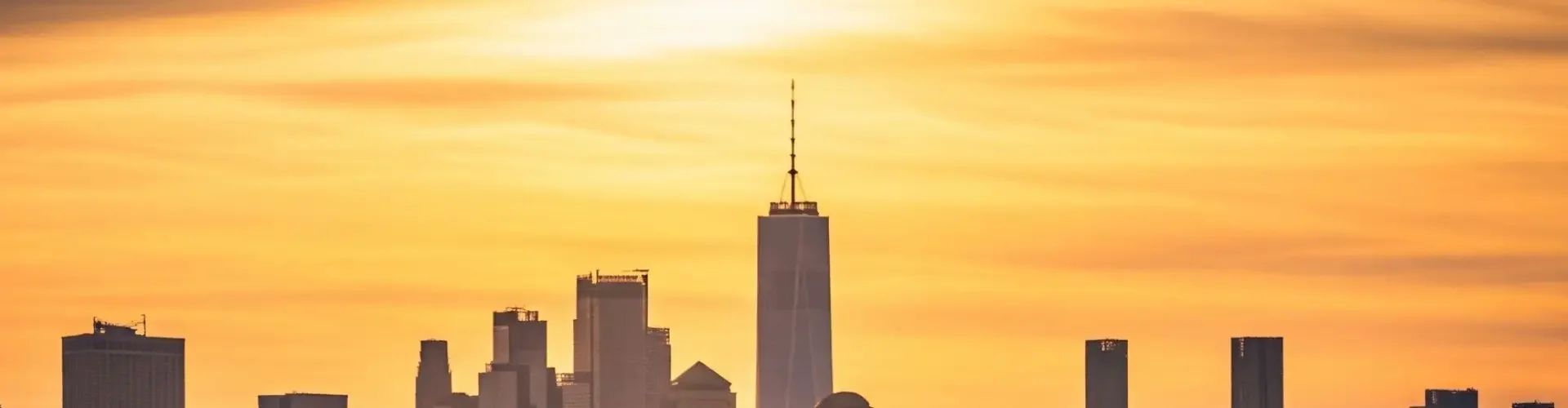 What Is the Average Cost to Fly Privately in the US? Luxury private jet positioned on tarmac with Manhattan skyline glowing during golden hour sunset