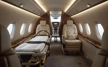 Medical aircraft interior with stretcher bed and luxury seating configured for air ambulance services