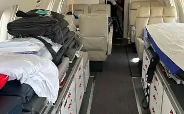 Medical equipment and stretcher bed inside air ambulance cabin configured for emergency patient transport