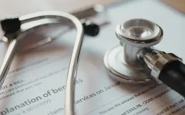 Bed-to-Bed Medical Transport Explained in Canada Medical stethoscope resting on patient transfer documents for bed-to-bed healthcare services in Canada