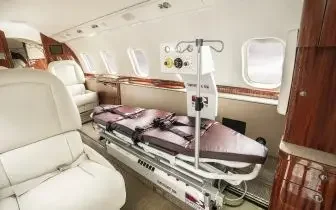 Medical stretcher installed in luxury private jet cabin for air ambulance and medevac charter services