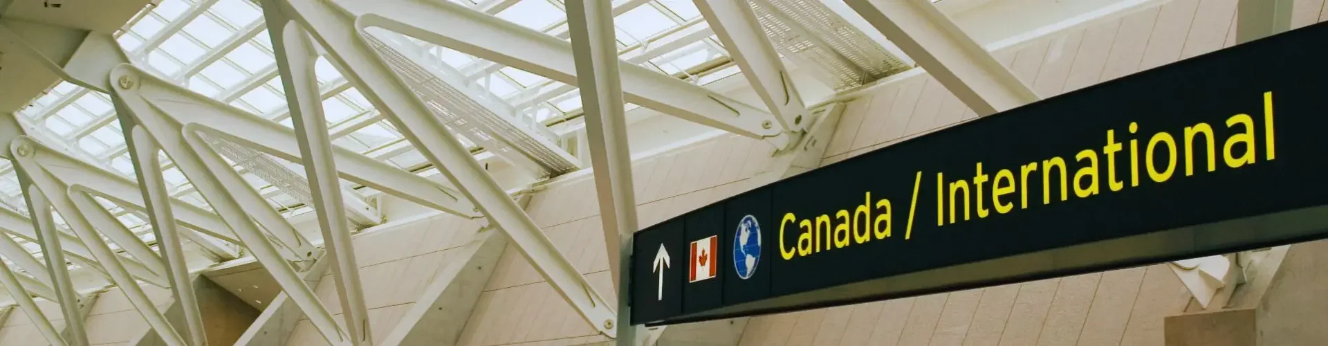 Private Jet from Toronto Pearson Airport to Los Angeles Modern airport terminal with glass ceiling and Canada International departure gate signage