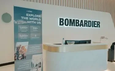 Inside Bombardier’s Expanded Mega Service Centre Modern Bombardier reception area with company branding and promotional banner for luxury aviation networking