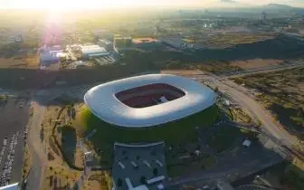 Modern stadium oval architecture desert landscape golden hour sunset card item for private jet charter passengers