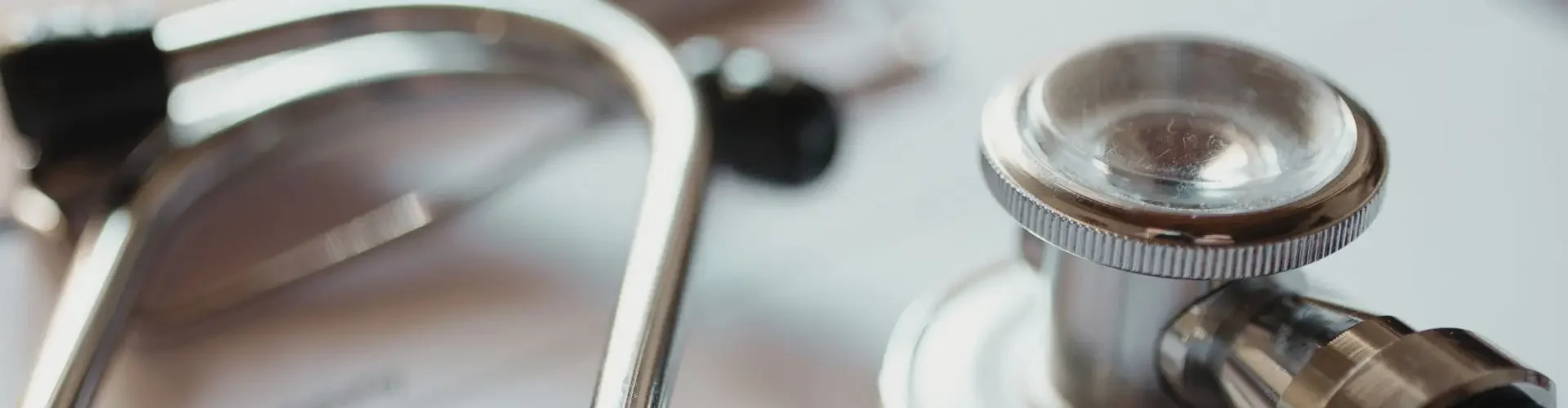 Cost & Insurance Considerations for Medical Flights in Canada Medical stethoscope resting on insurance documents highlighting healthcare coverage for air ambulance services