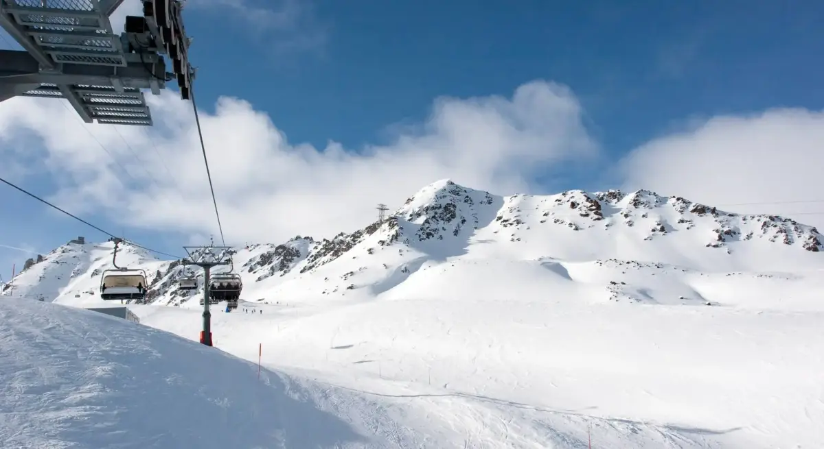 Pristine ski slopes and chairlift system at luxury Alpine resort accessible by private jet charter