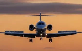 Private jet approaching during golden hour sunset, showcasing luxury aircraft for UK charter flights