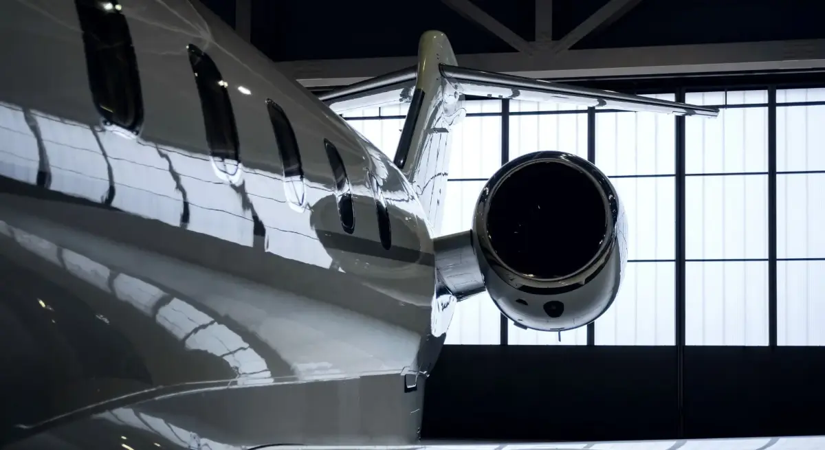 Sleek private jet engine and fuselage in modern hangar showcasing aircraft selection considerations