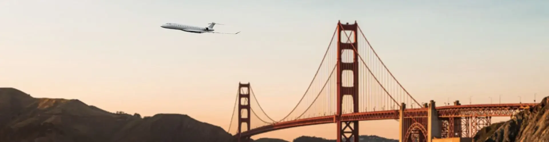 Private jet soaring over Golden Gate Bridge at sunset with San Francisco Bay waters below