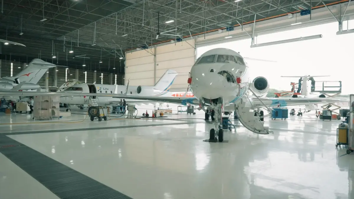 Professional aircraft maintenance hangar showcasing luxury private jets during exclusive VIP networking event