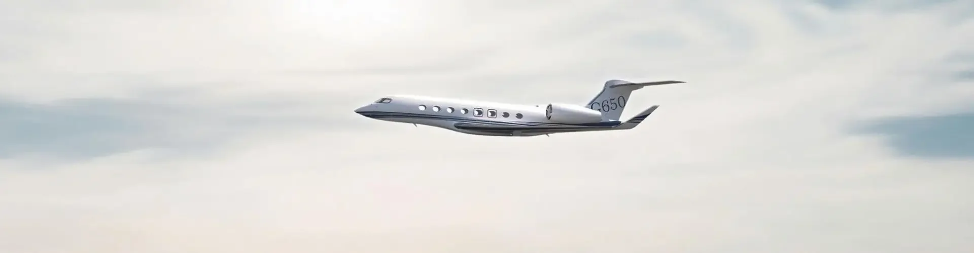 Woman in wide-brimmed hat watches luxury private jet fly over sparkling ocean from yacht deck