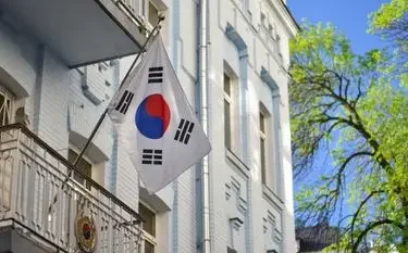 South Korean flag flying outside elegant white building facade for luxury Seoul art fair travel