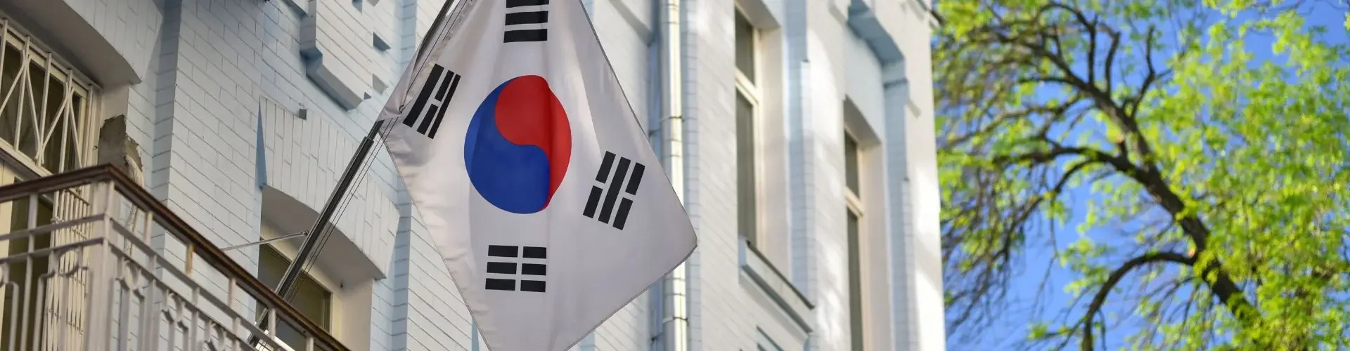 South Korean flag flying outside elegant white building facade for luxury Seoul art fair travel