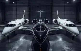 Three luxury private jets positioned in modern hangar showcasing UK charter fleet options and pricing