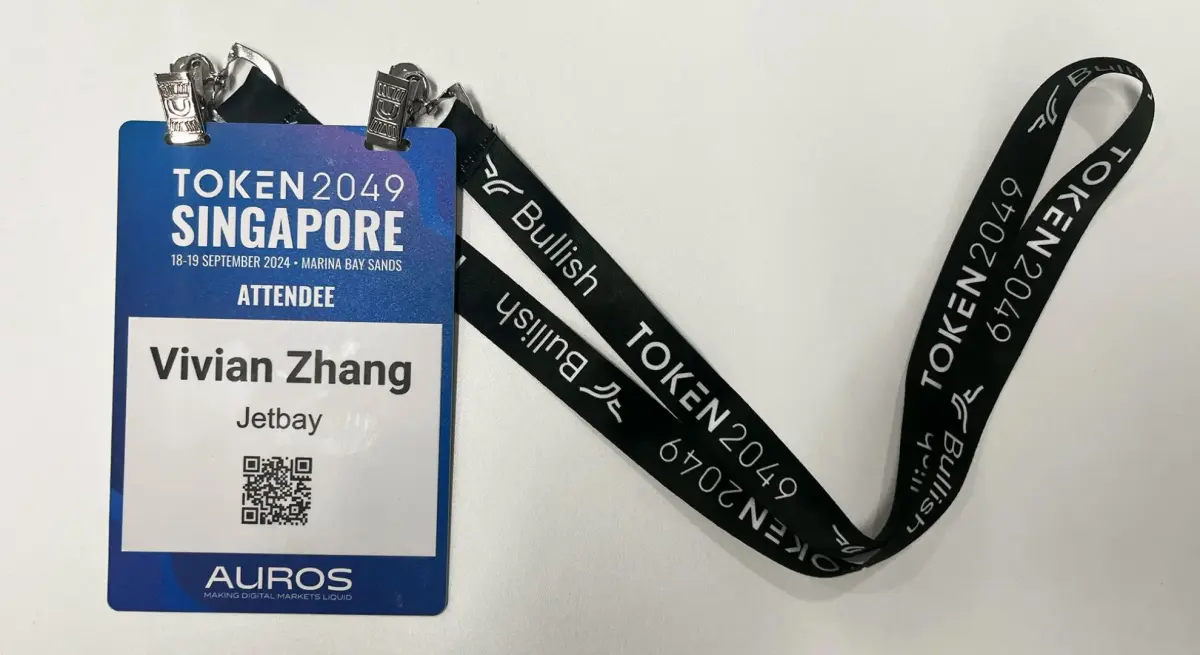 TOKEN2049 Singapore conference attendee badge for Jetbay representative with black lanyard on white background