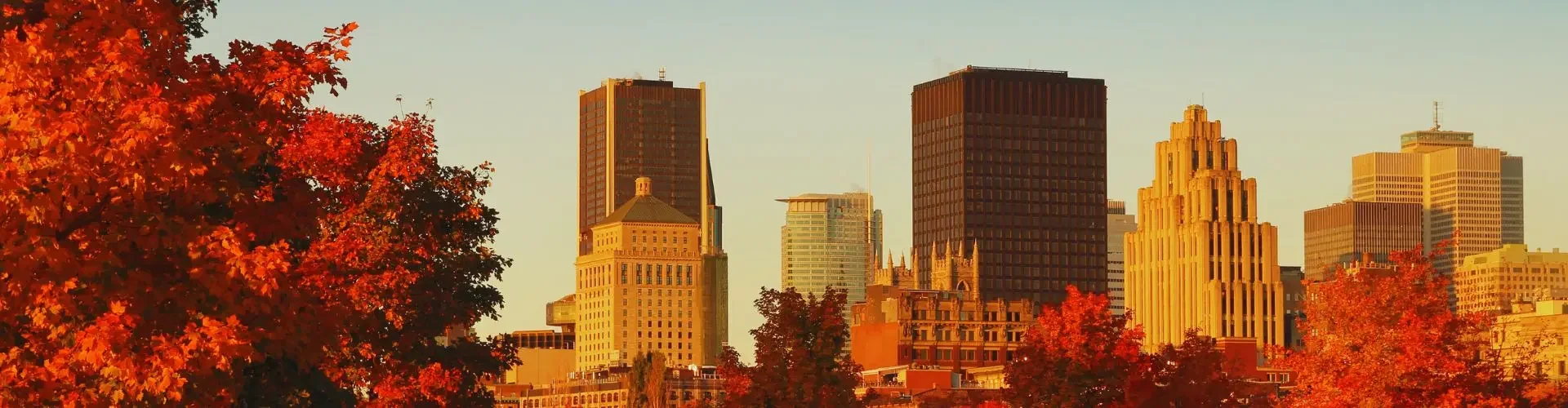 Private Jet from Montréal to Toronto Toronto skyline at golden hour with vibrant autumn foliage framing downtown towers and waterfront