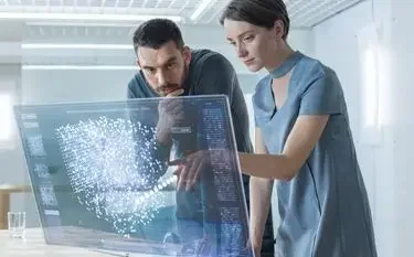How Jetbay Uses AI to Match You With the Perfect Aircraft and Operator Two professionals analyzing AI-powered flight matching data on holographic display for private jet booking