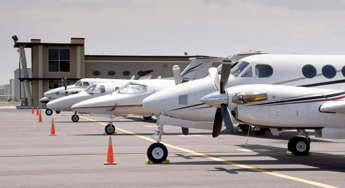 White private jets parked at modern airport terminal, showcasing luxury aircraft options for TIFF travel