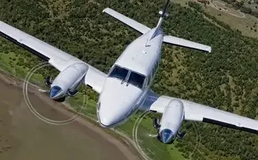 White twin engine private aircraft east midlands countryside green fields for private jet charter passengers