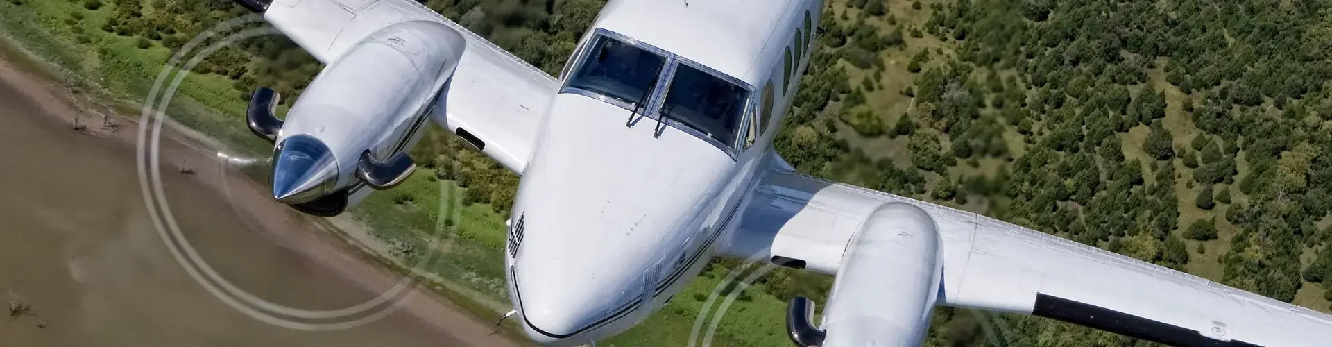 White twin engine private aircraft east midlands countryside green fields for private jet charter passengers