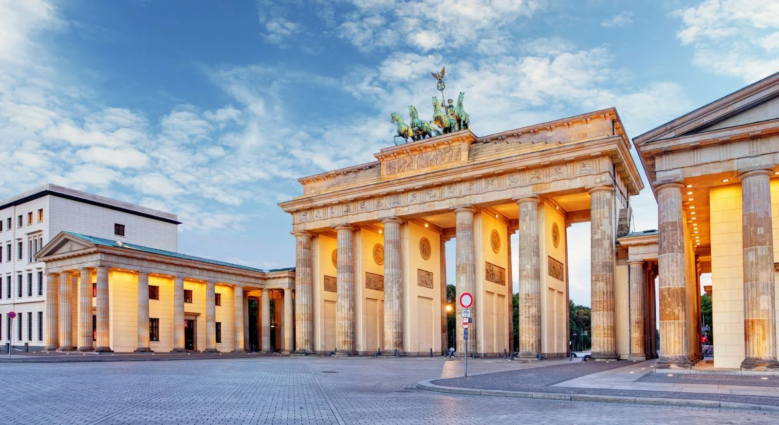 Brandenburg Gate illuminated at dusk showcasing Berlin's iconic neoclassical architecture and luxury travel destination