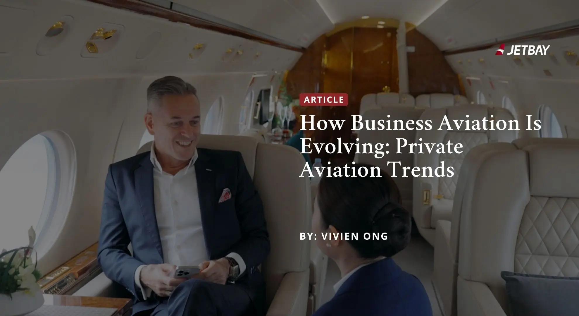 Business executives discussing aviation trends in luxury private jet cabin with JETBAY branding