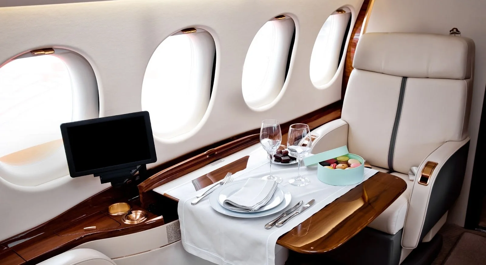 Elegant private jet cabin interior with formal dining setup showcasing luxury amenities for Dublin-Budapest flights