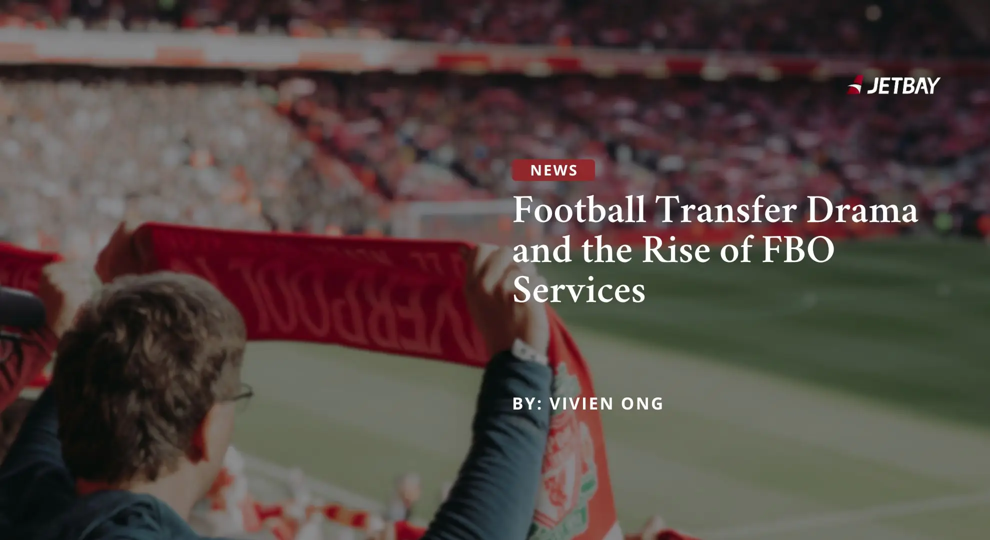Football fans waving red scarves in stadium stands supporting Liverpool FC during match day atmosphere