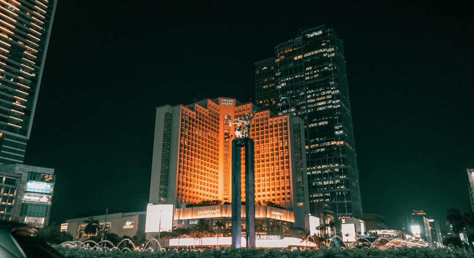 Jakarta's illuminated Grand Hyatt hotel and modern skyscrapers at night showcasing luxury travel destinations