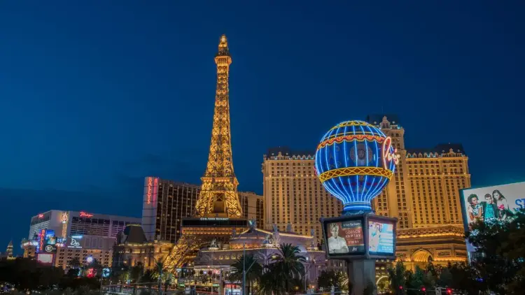 Las Vegas Strip illuminated at twilight featuring Eiffel Tower replica and Paris hotel for luxury travel