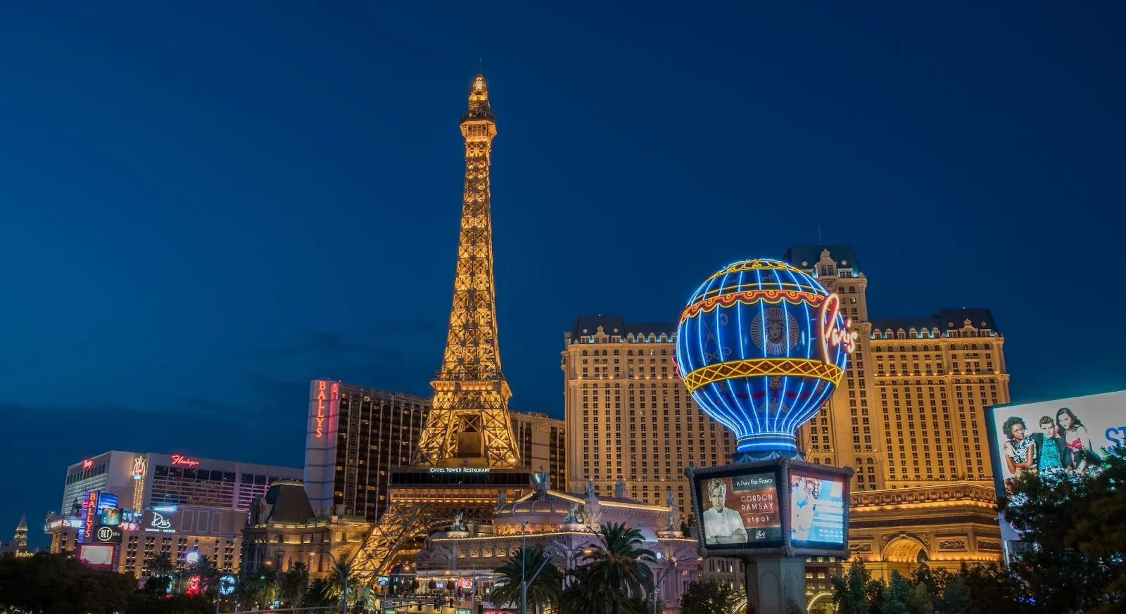 Las Vegas Strip skyline at dusk featuring illuminated Eiffel Tower replica and luxury hotels for private jet travelers