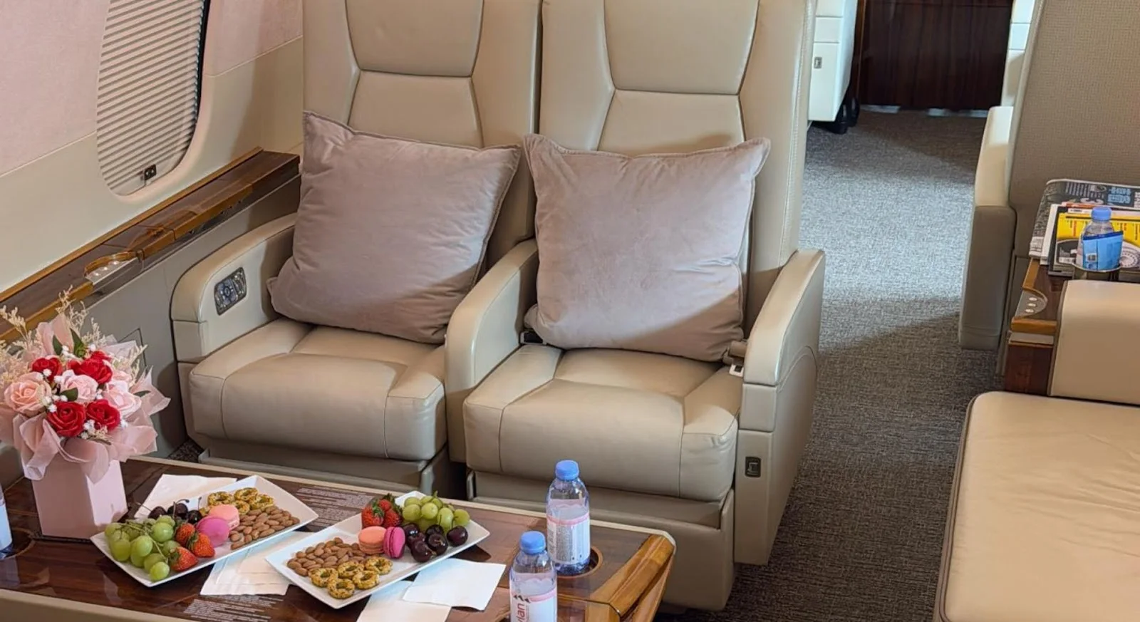 Luxurious private jet cabin interior with premium leather seating and gourmet refreshments for Hong Kong to Dubai flights