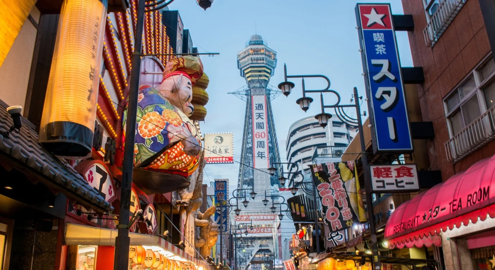 Vibrant Osaka street scene with iconic Tsutenkaku Tower and colorful neon signs showcasing Japan's urban culture
