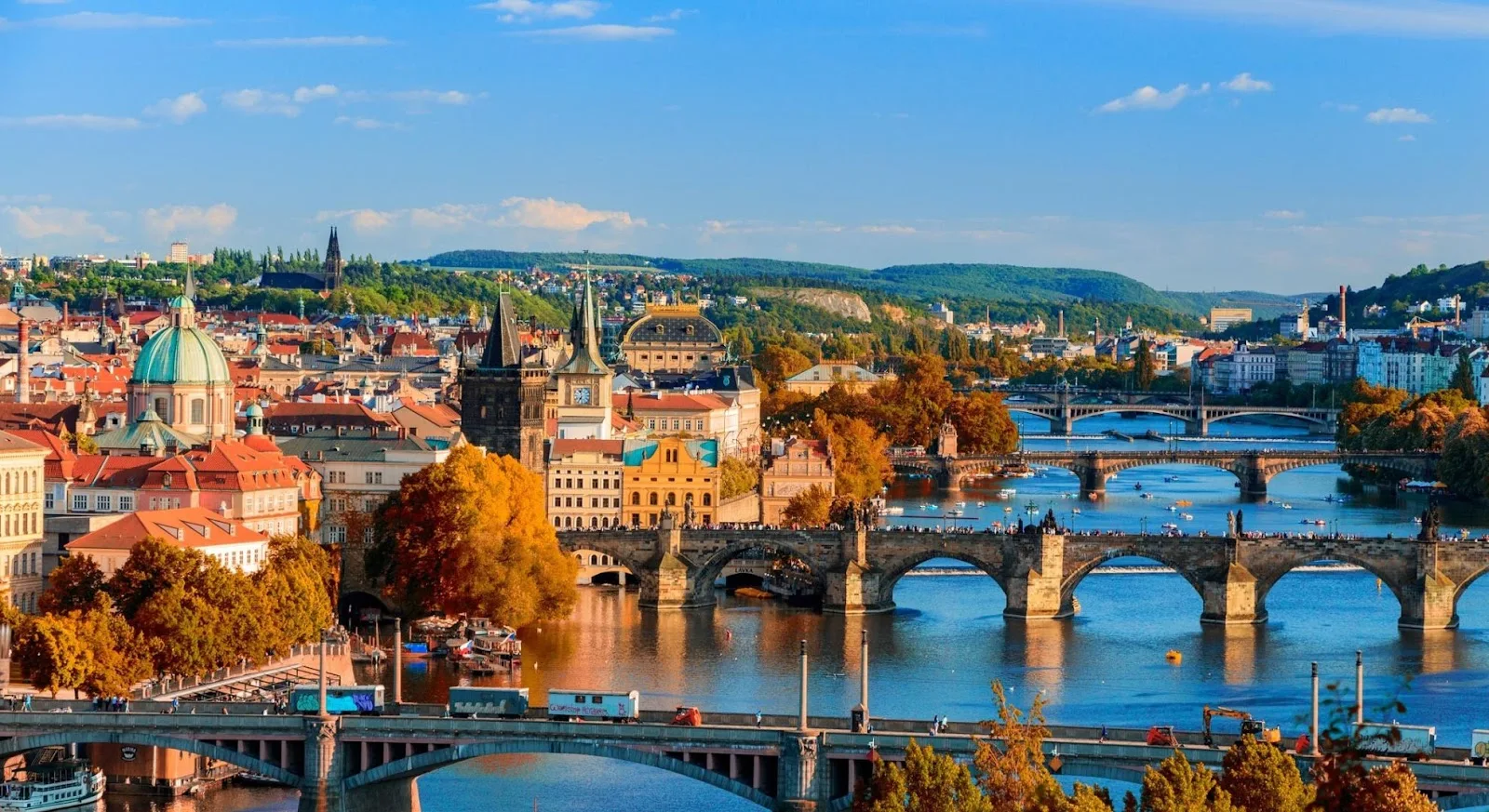 Prague's historic Charles Bridge and colorful baroque architecture along the Vltava River in autumn