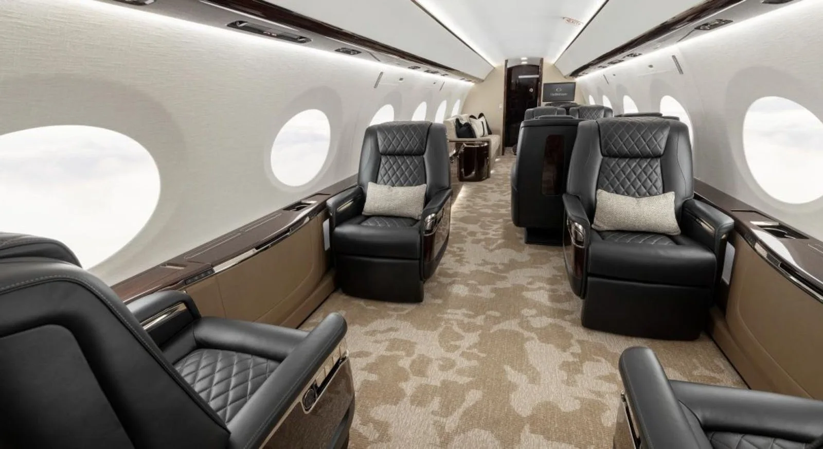Spacious private jet cabin interior with quilted leather seats and premium amenities for luxury travel